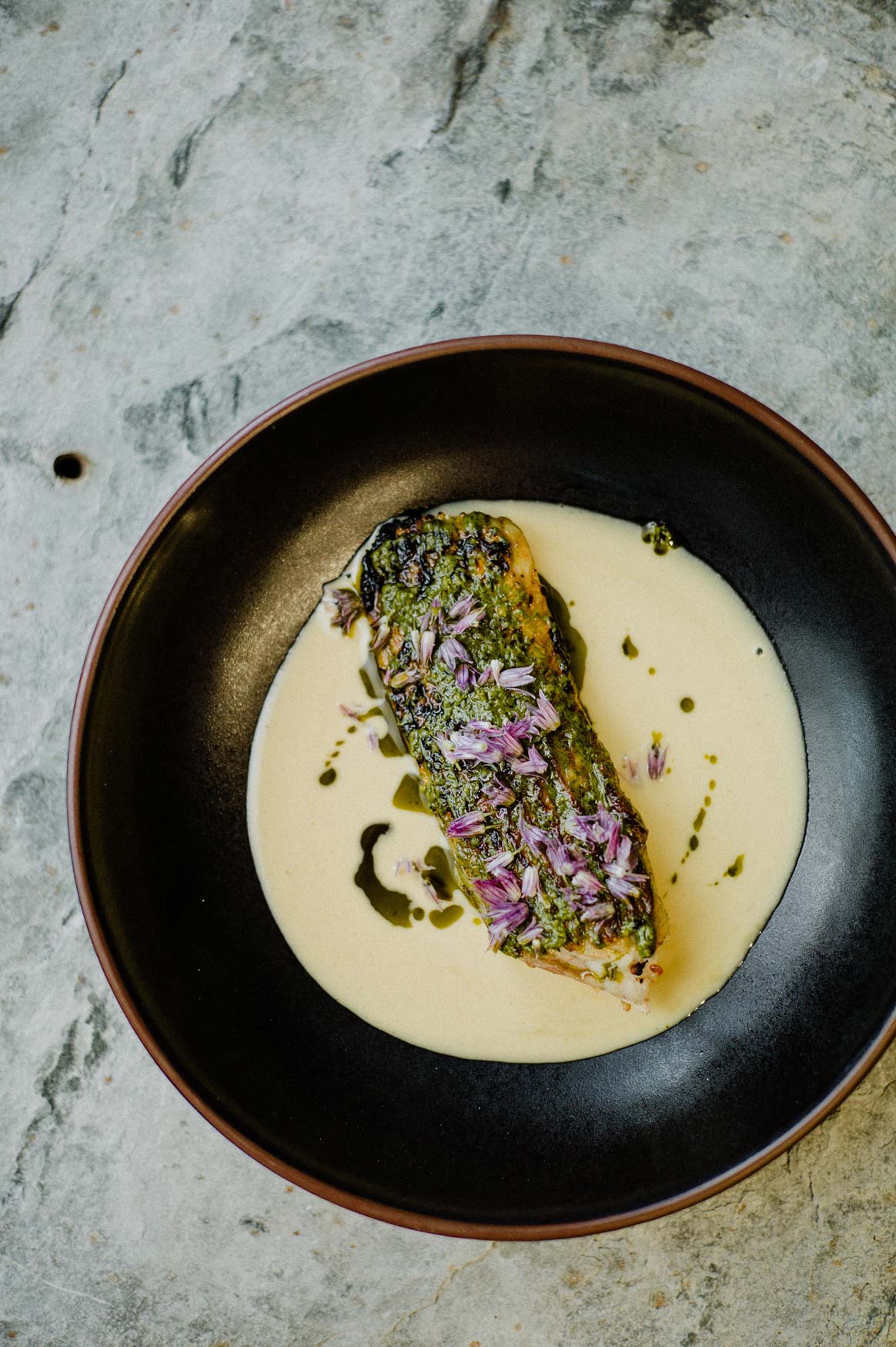Fish topped with seasonal herbs and wild flowers